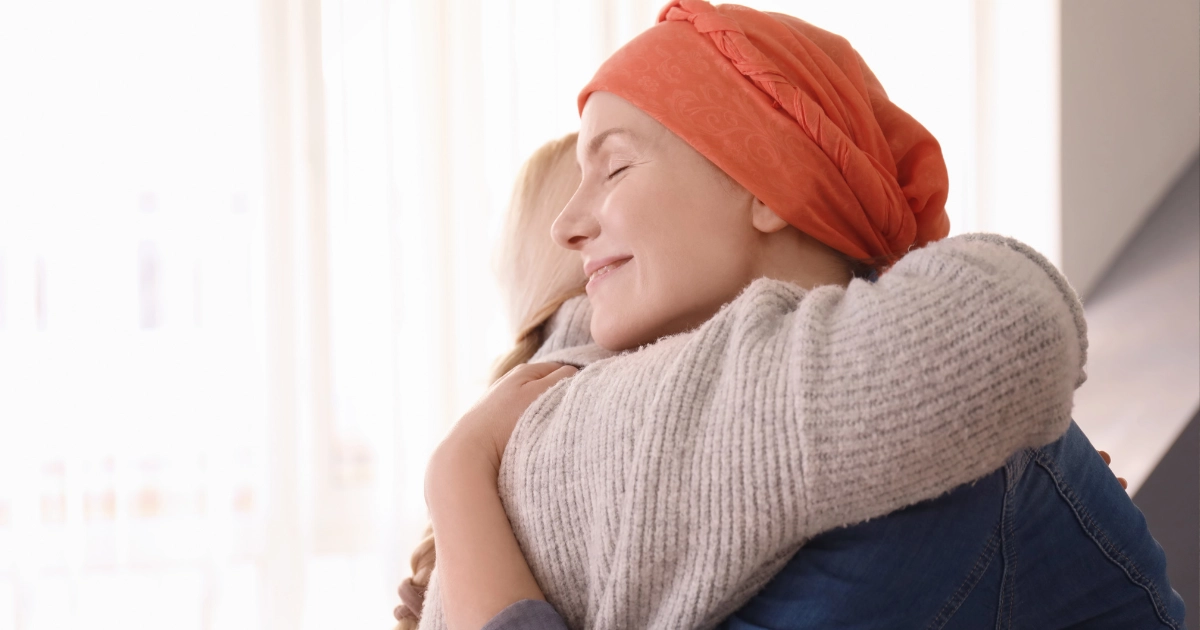 hugging happy and relieved couple who recieved acupunture after cancer treatment